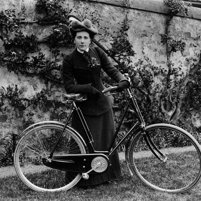 Athletic Young Female In Sports Attire Poses With Her Bicycle