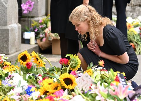 lady louise windsor views the flowers left by mourners outside balmoral castle