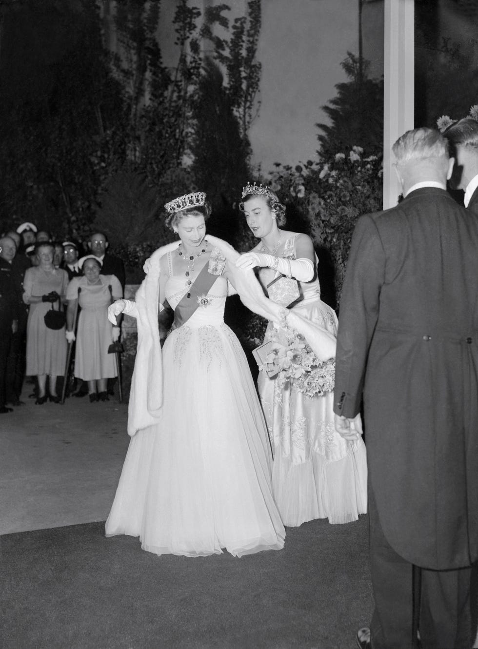 lady pamela mountbatten, right, lady in waiting, adjusts queen elizabeth's stole at the roya