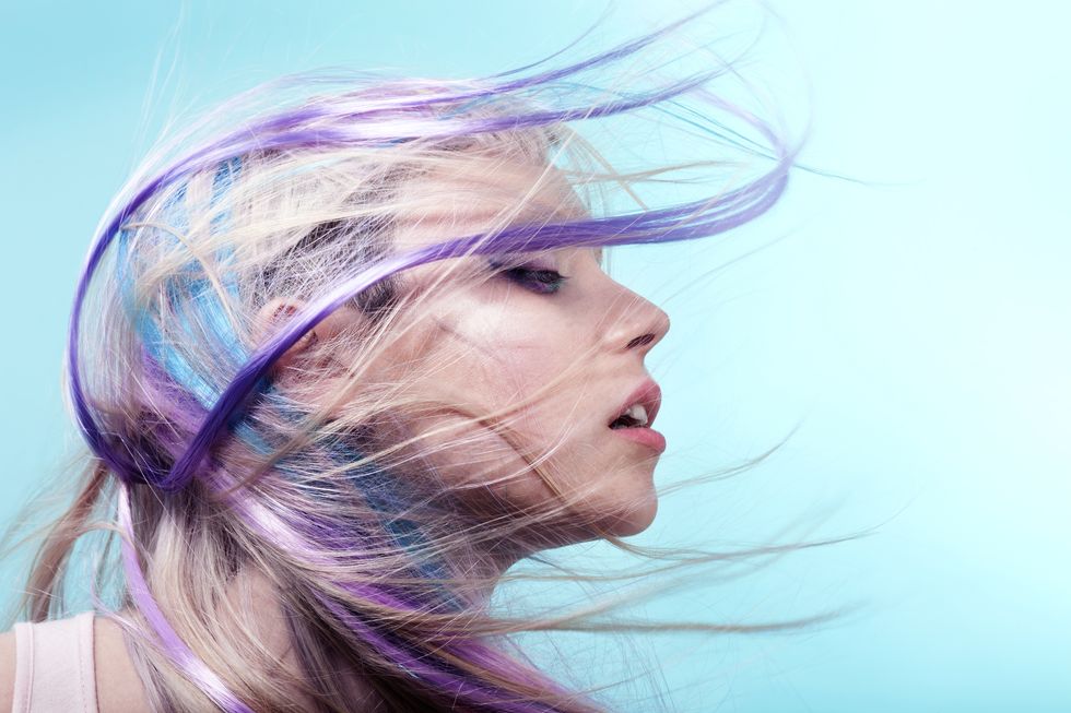 Lady with colorful hair flying over her face
