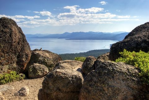 Lake Tahoe is framed by large granite boulders on the Tahoe Rim Trail, CA.