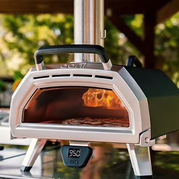 two ooni pizza ovens in use in a garden