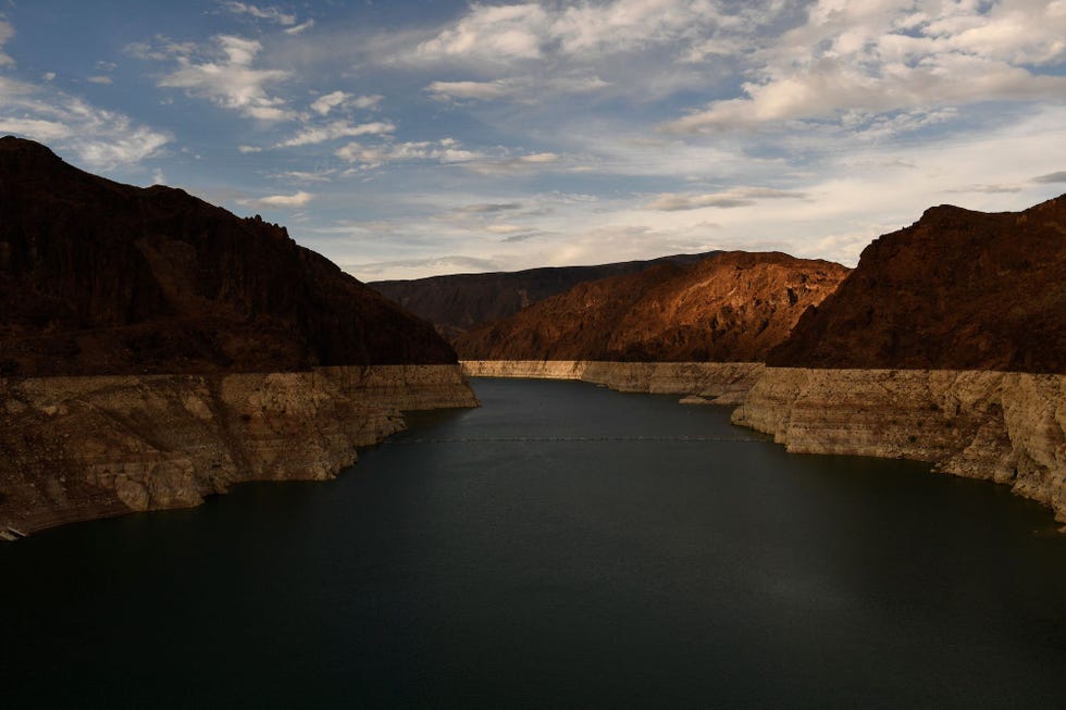 topshot   a "bathtub ring" is visible at sunset during low water levels the lake mead reservoir due to the western drought on july 19, 2021 as seen from the hoover dam on the colorado river at the nevada and arizona state border   the lake mead reservoir formed by the hoover dam on the nevada arizona border provides water to the southwest, including nearby las vegas as well as arizona and california, but has remained below full capacity since 1983 due to increased water demand and drought, conditions that are expected to continue photo by patrick t fallon  afp photo by patrick t fallonafp via getty images