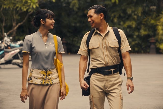 interaction between two individuals one in civilian attire and the other in a uniform