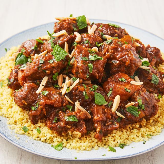 lamb tagine sstew topped with mint over couscous on a plate
