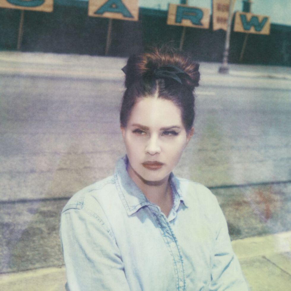 lana del ray album cover featuring her wearing a blue denim shirt and her hair up in a bun looking off to the side