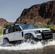 the 2020 land rover defender fording a stream in a off road mountain setting