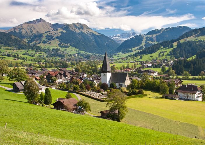 landscape near gstaad, summer view to saanen church and village