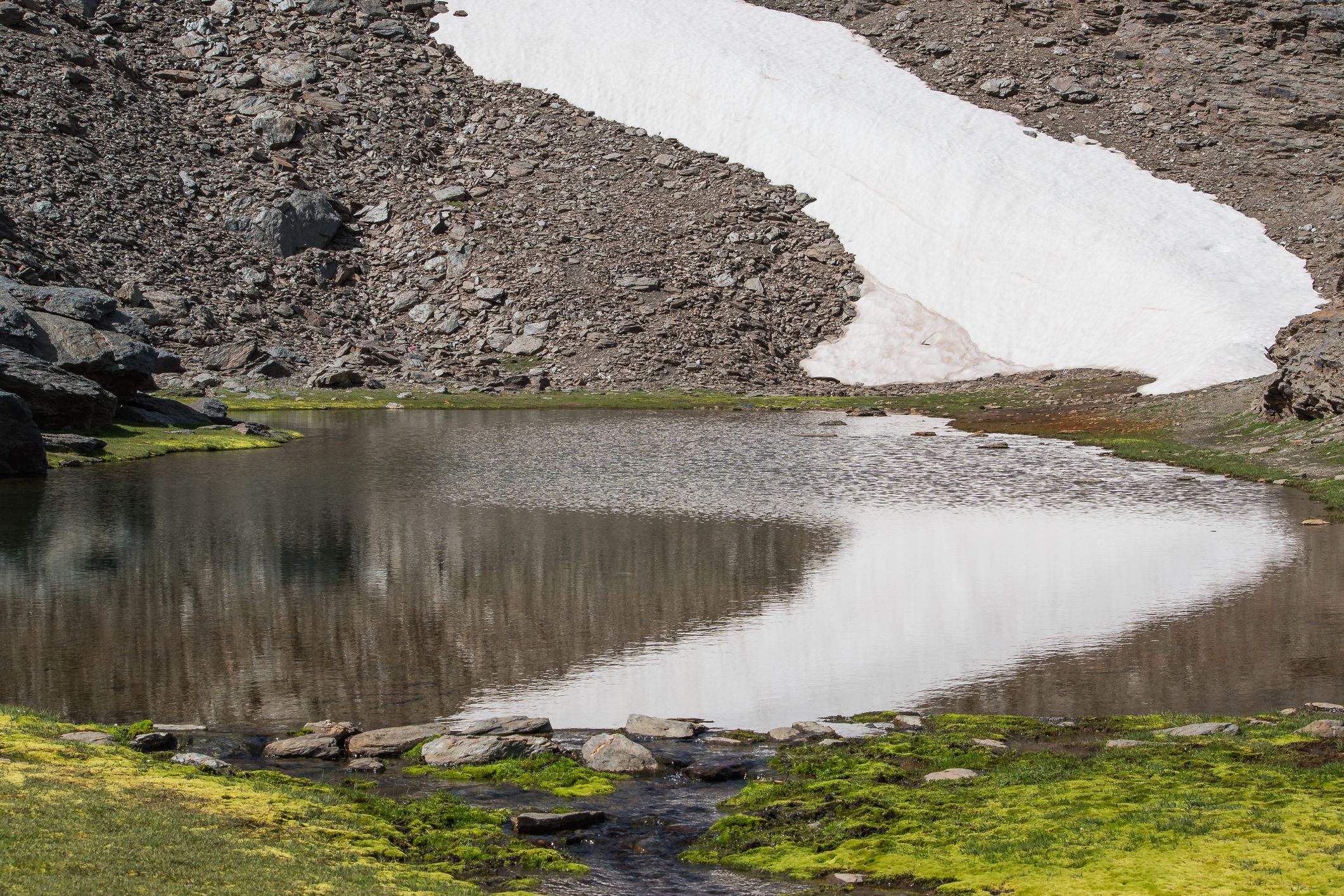 landscape with lake and snow on hillside, güéjar sierra, spain