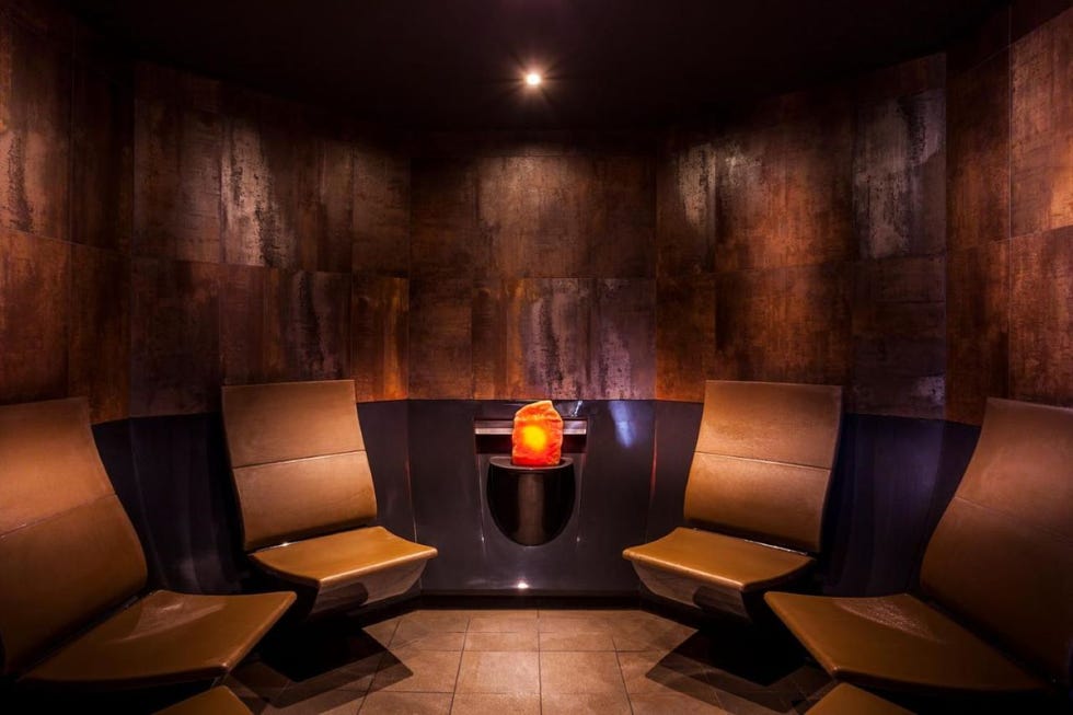 a room with chairs and a table with a hot stone