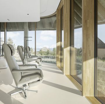a room with a large window and chairs