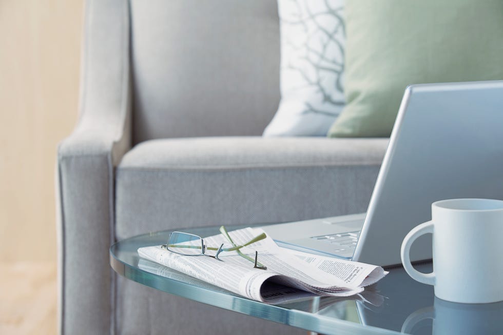 laptop and eyeglasses on coffee table