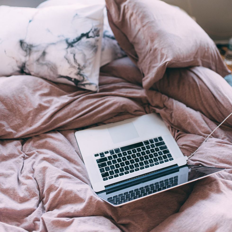 money saving tips   laptop on bed