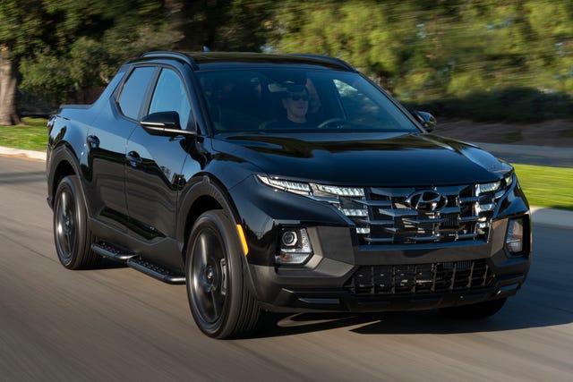 2023 hyundai santa cruz night driving down a suburban street