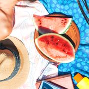 beach towels with watermelon, sunscreen, hat, phone