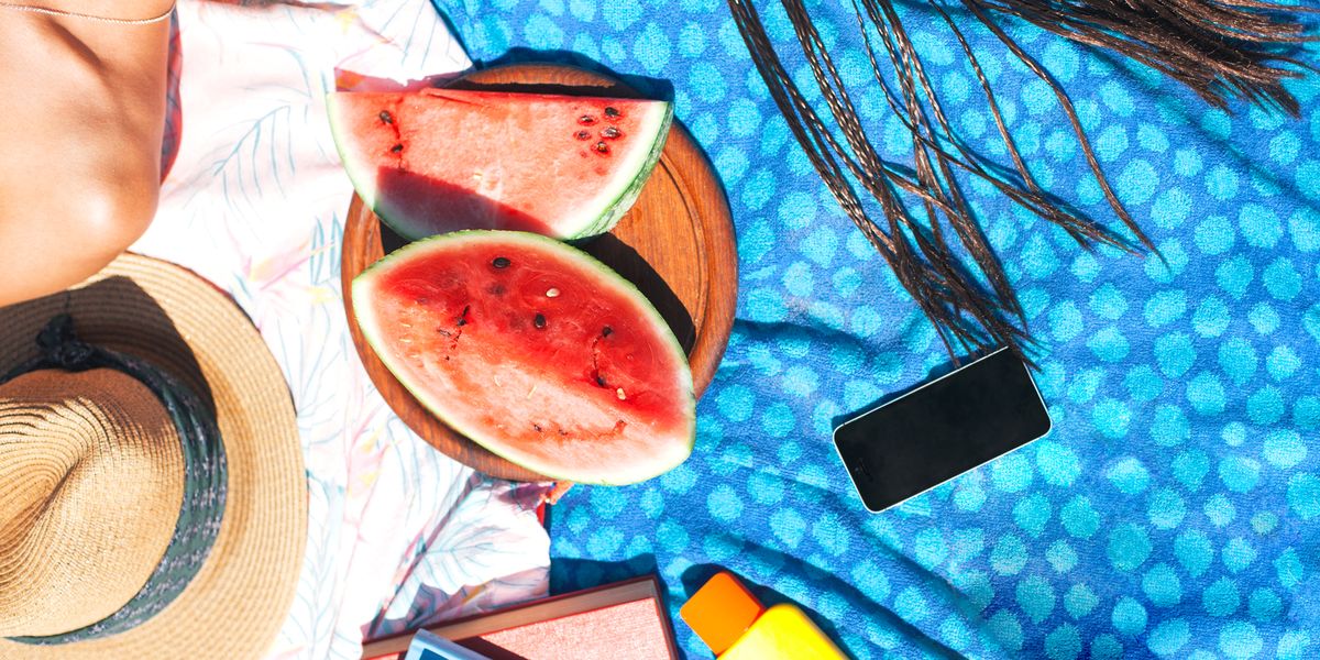 beach towels with watermelon, sunscreen, hat, phone
