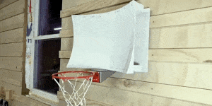 a basketball going into a hoop with a curved backboard in slow motion