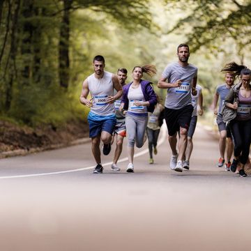 large group of athletes running a marathon on the road.