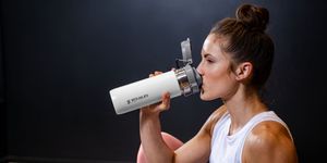 woman drinking from water bottle