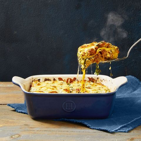 lasagna with meat sauce in a blue baking dish