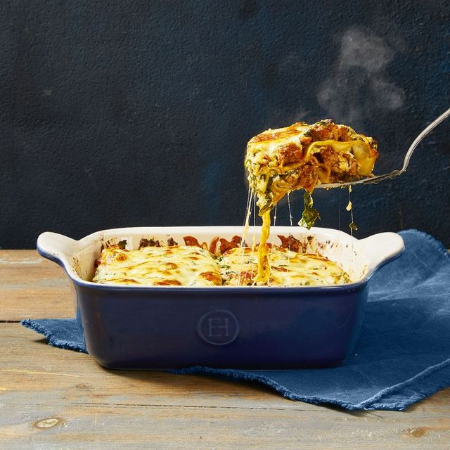 lasagna with meat sauce in a blue baking dish
