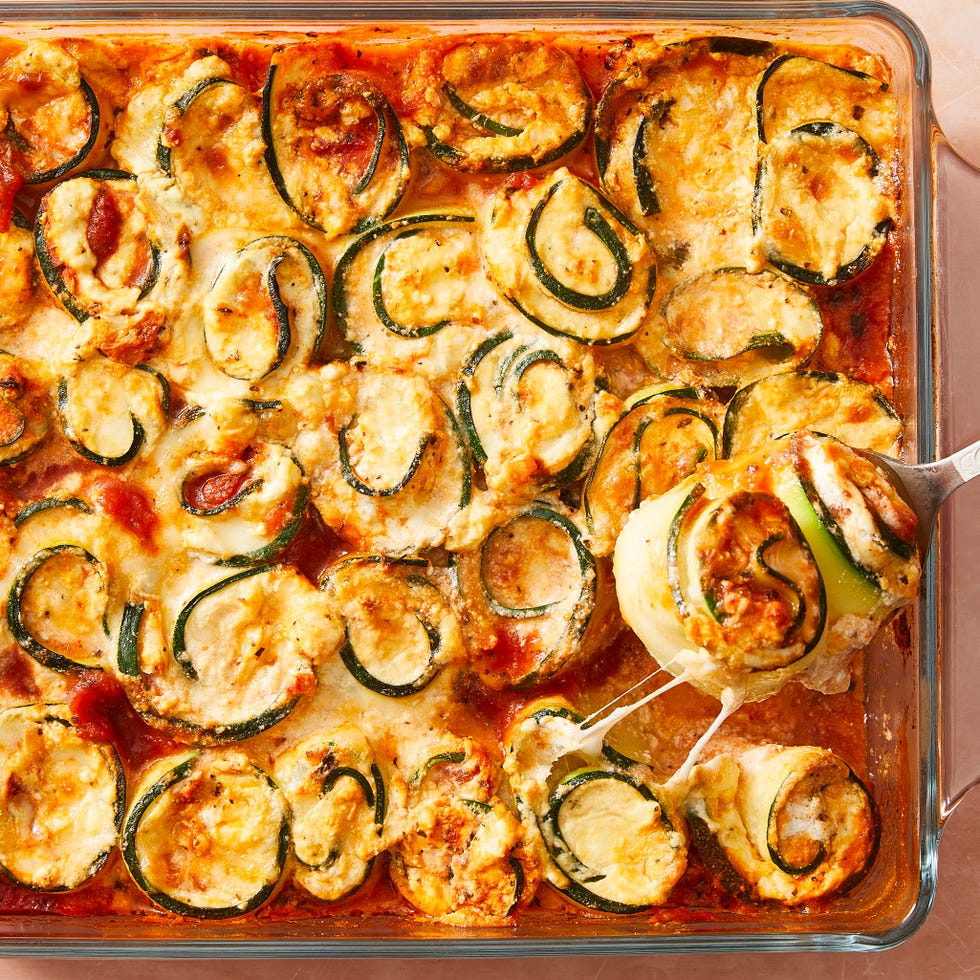 Roll zucchini slices in cheese, pour sauce over and place in casserole dish.