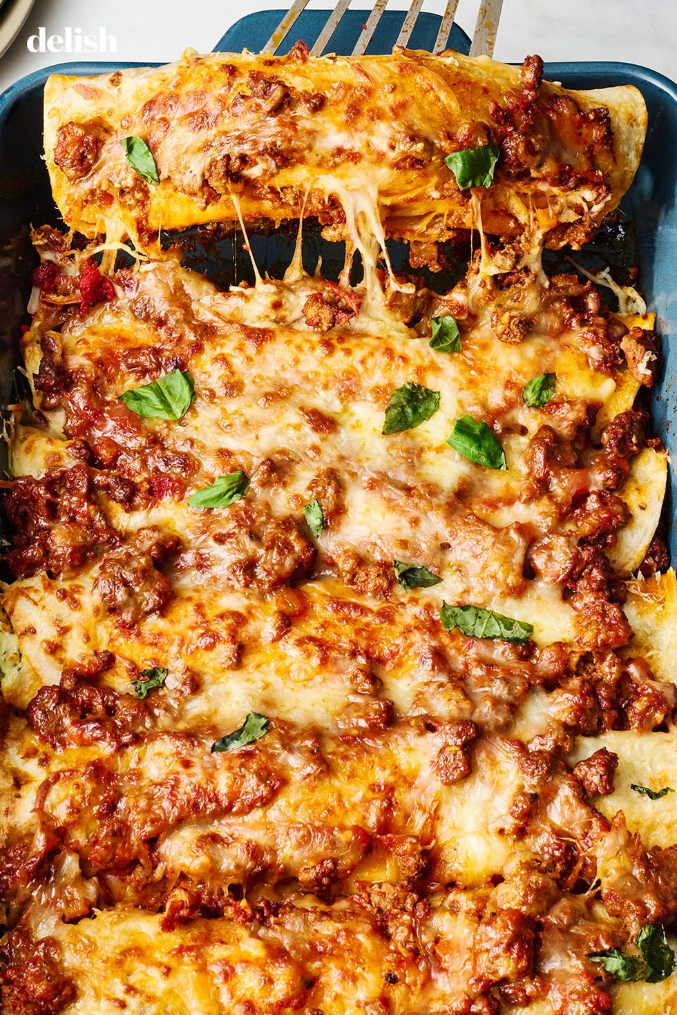 saucy beef bolognese and herby ricotta rolled into flour tortillas, and topped with more bolognese, mozzarella, and parmesan, then baked until bubbly and perfect