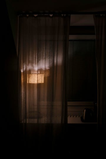 soft light illuminating a curtain in a dimly lit room