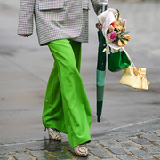 woman walking holding flowers