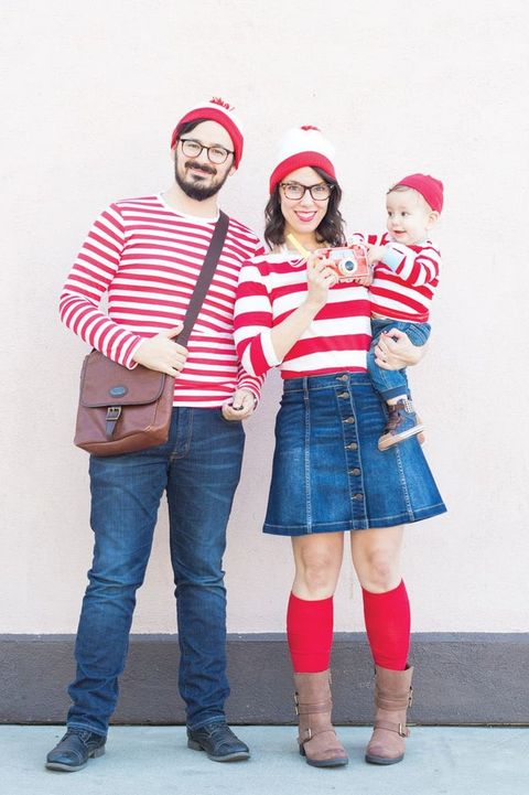 parents and baby dressed in last minute where's waldo costumes with red and white stripe shirts and caps and denim bottoms
