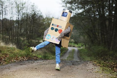boy outdoors wearing robot halloween costume made last minute from cardboard boxes, old cds, other odds and ends