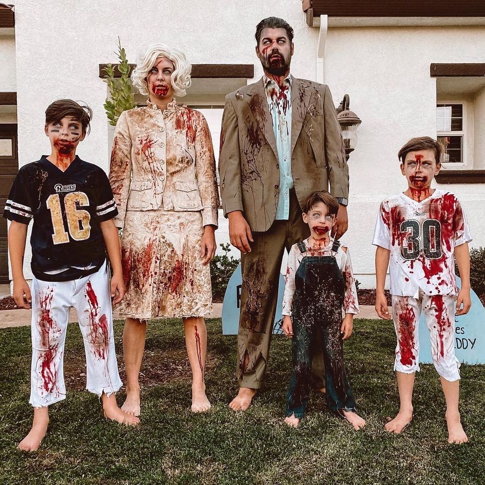 family in last minute zombie costumes made of football uniforms, suits and overalls stained with coffee grinds and fake blood
