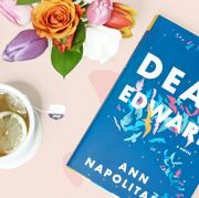 dear edward novel with bouquet of flowers and cup of tea
