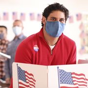 latin descent man votes in usa election wearing mask