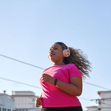 latin woman with large build running in city