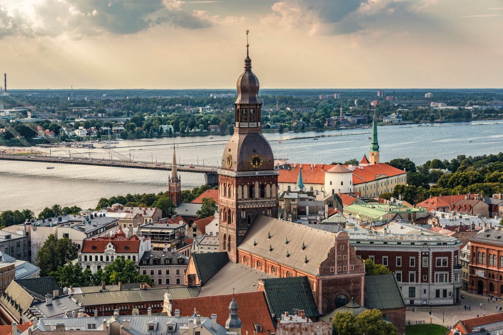 latvia, riga, cityscape with cathedral, castle and vansu bridge