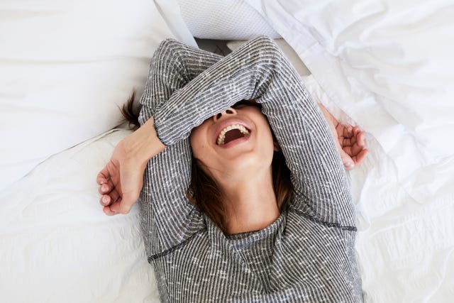 Laughing babe in bed