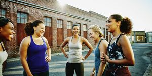 laughing group of women resting after run