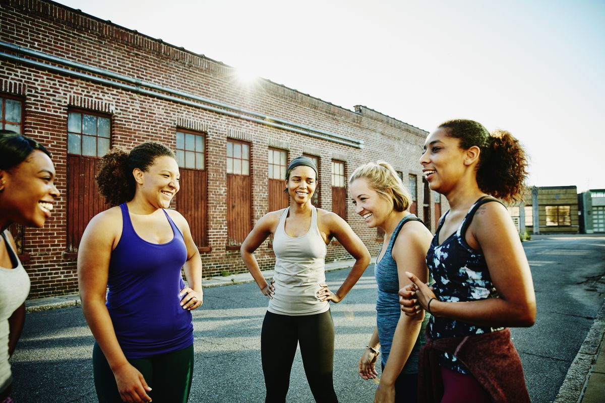 laughing group of women resting after run