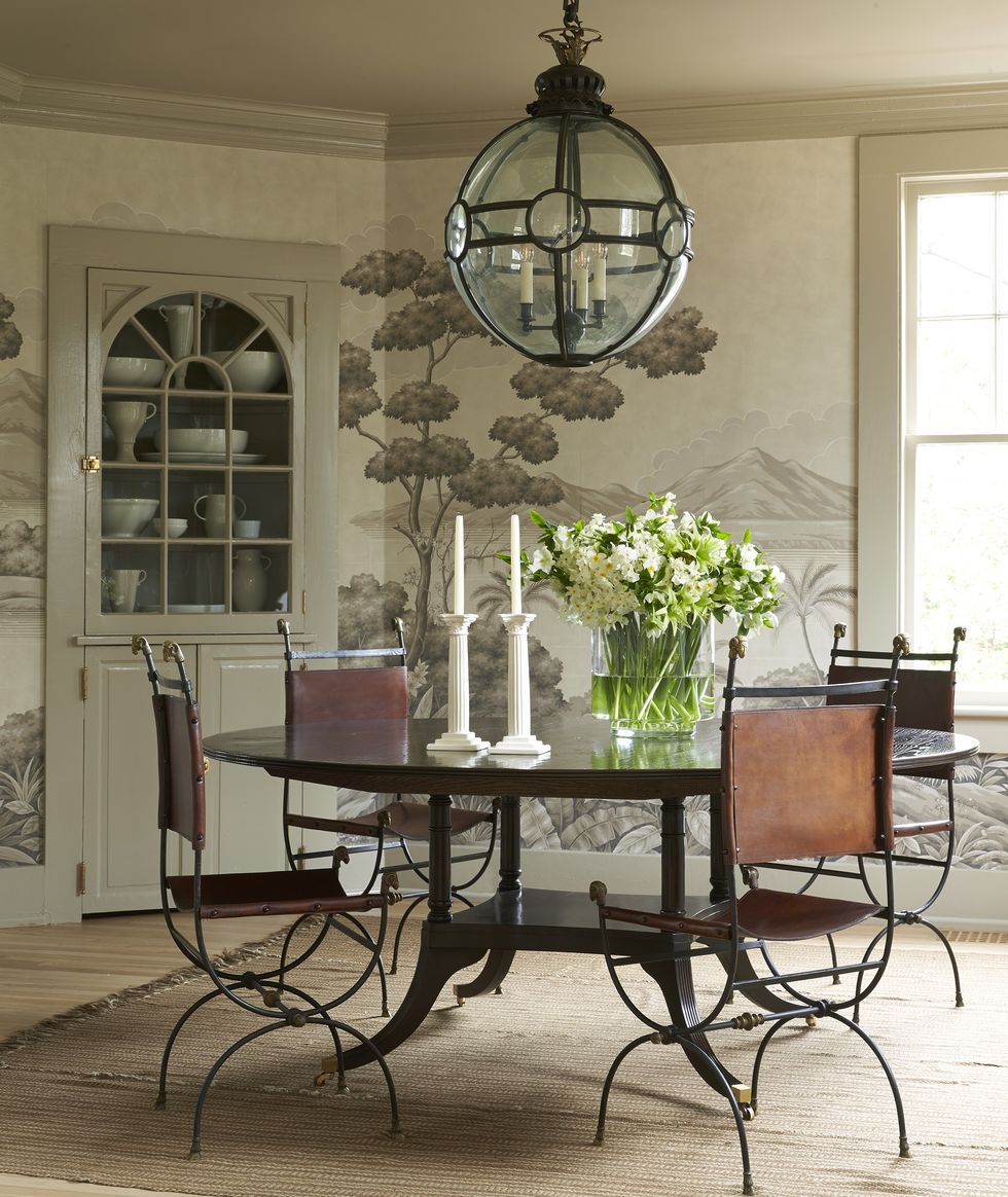 a dining room table with a chandelier above it