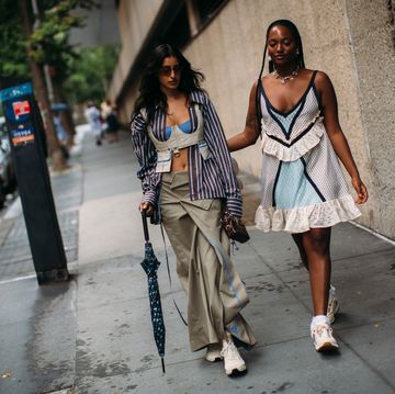 two women walking down a sidewalk
