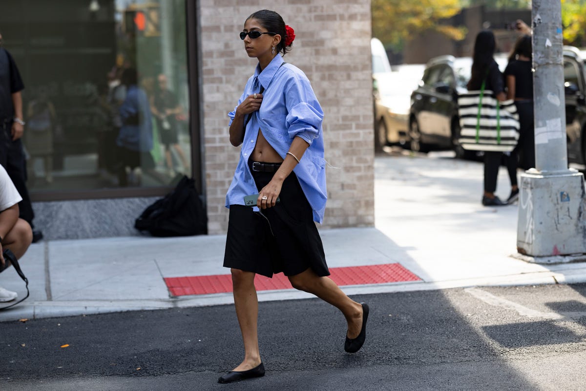 a person in a skirt walking on the street