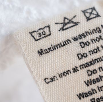 laundry care washing instructions clothes label on fabric texture background