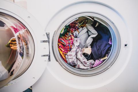 laundry day.Washing machine full of colorful clothes