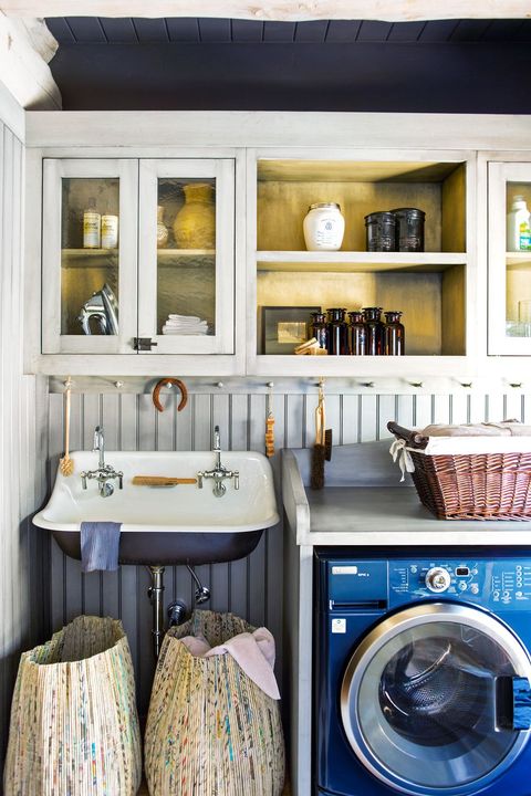 laundry room with brass shelving and navy washer