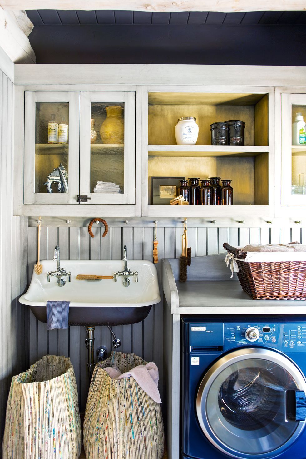 blue laundry room with wall mounted laundry room sink