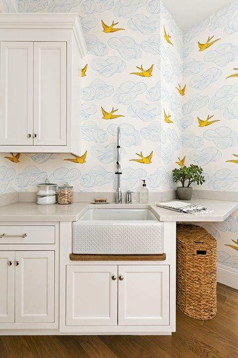 laundry room with bright patterned wallpaper