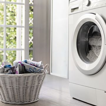 laundry room with washing machine and laundry basket