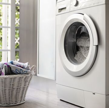 laundry room with washing machine and laundry basket