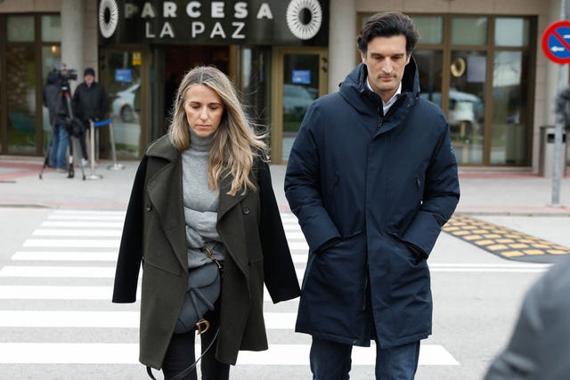 a man and woman walking on a street